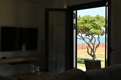 a sliding glass door with a view of a tree at Unick Avra Luxury Living in Kalathas