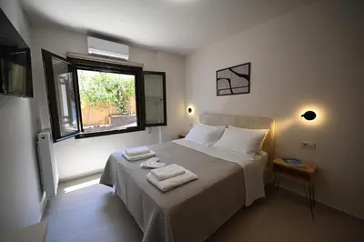 a bedroom with a bed with two towels on it at Unick Avra Luxury Living in Kalathas