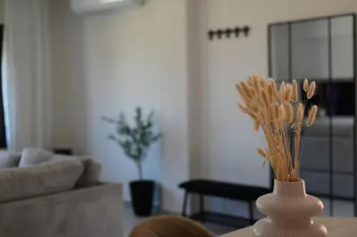 a white vase sitting on a table in a living room at Unick Avra Luxury Living in Kalathas