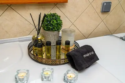 a tray with oils and candles on a bathroom sink at Happy House-Steps from Nea Chora Beach in Chania Town