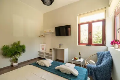 a living room with two pillows on a blue rug at Casa Chris in Chania Town