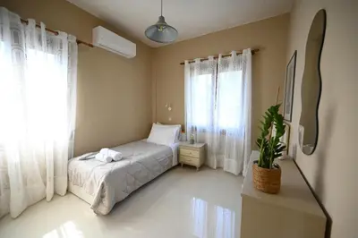 a bedroom with a bed and a potted plant at Unick Seaview Luxury Living in Kalathas