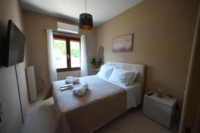 a bedroom with a bed with two stuffed animals on it at Unick Seaview Luxury Living in Kalathas