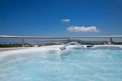 a hot tub with water coming out of it at Slavena Suite in Perivólia