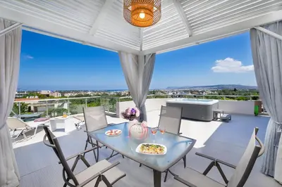 a dining room with a table and chairs at Slavena Suite in Perivólia