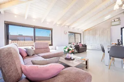 a living room with a couch and a table at Slavena Suite in Perivólia