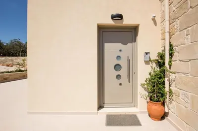 a door with a plant next to a building at Amfitriti Villa in Gramvousá