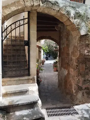 an archway in a stone building with a gate at Lili House in Chania Town