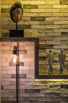 a brick wall with a statue and a lamp at Cosy 1st floor apartment at Koum Kapi Beach in Chania Town