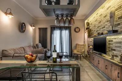 a living room with a couch and a table at Cosy 1st floor apartment at Koum Kapi Beach in Chania Town