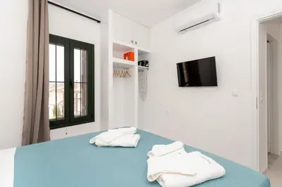a bedroom with a blue bed with two towels at Manoli's Studios Old Town Chania in Chania Town