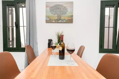 a table with two bottles and two glasses of wine at Manoli's Studios Old Town Chania in Chania Town