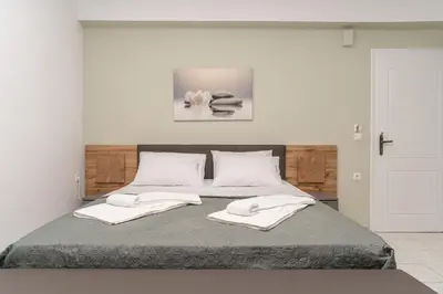 a bedroom with a bed with two towels on it at Manoli's Studios Old Town Chania in Chania Town