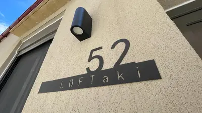 a sign on the side of a building at LOFTaki - Petite house next to Koum Kapi beach in Chania Town
