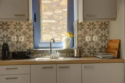 a kitchen counter with a sink and a window at Metoxaki in Dhaskalianá