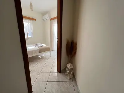 a room with a bedroom with a bed and a mirror at Aria Aparment in Palaiochóra