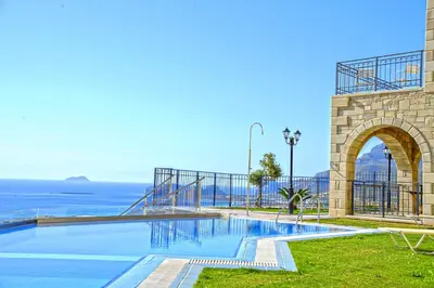 a swimming pool with a view of the ocean at Fotini Traditional Villas in Kavoúsion