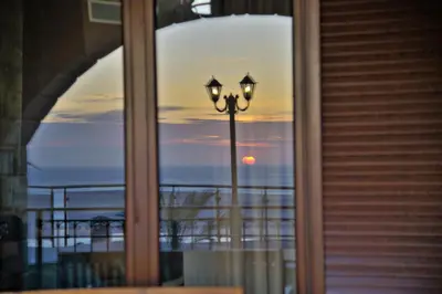 a view of the ocean from a window with a street light at Fotini Traditional Villas in Kavoúsion