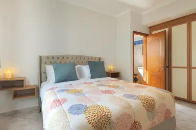 a bedroom with a large bed with blue pillows at Solena in Tsikalariá