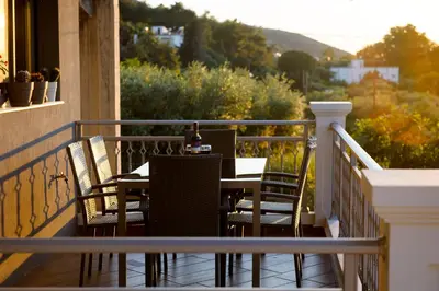 a table and chairs on a balcony with a view at Solena in Tsikalariá