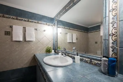 a bathroom with a sink and a mirror at Solena in Tsikalariá