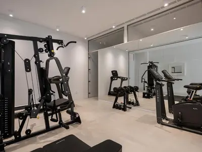 a gym with several tread machines in a room at Nature & Beauty Villa in Xirostérnion