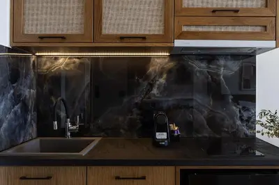 a kitchen with a sink and a cell phone on the counter at Mouria Luxury Suites - Adults Only in Falasarna