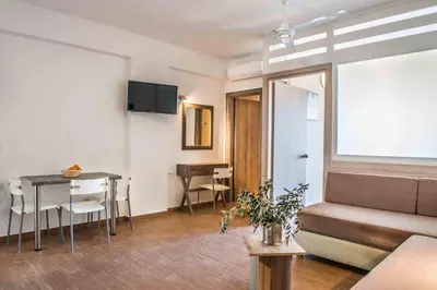 a living room with a couch and a table at Gerona Mare Apartments in Gerani Chanion
