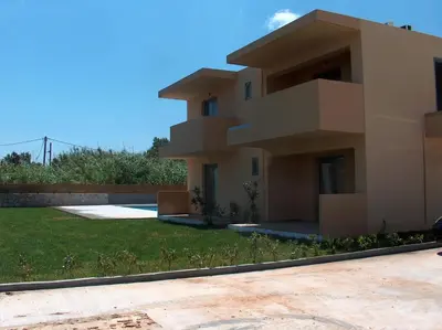 a large house with a yard in front of it at Gerona Mare Apartments in Gerani Chanion