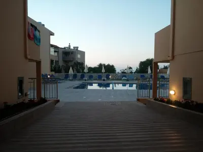 a view of a swimming pool from the balcony of a building at Gerona Mare Apartments in Gerani Chanion