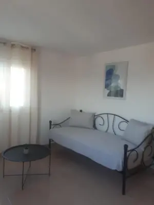 a bed and a table in a room at Cozy SeaView Apartment Walking Distance to Beach in Akhatzikiá