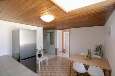 a kitchen and dining room with a wooden ceiling at Cozy SeaView Apartment Walking Distance to Beach in Akhatzikiá