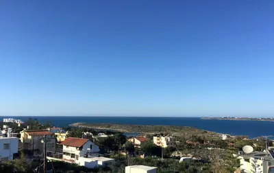 a view of a city and the ocean at Cozy SeaView Apartment Walking Distance to Beach in Akhatzikiá