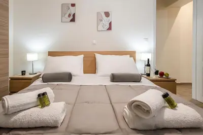 a bedroom with a large bed with towels on it at Perivolia Panorama - Peaceful Retreat with View in Perivólia