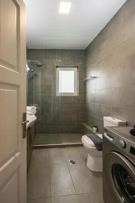 a bathroom with a shower and a toilet and a sink at Perivolia Panorama - Peaceful Retreat with View in Perivólia
