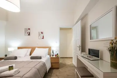 a bedroom with a bed and a desk with a computer at Perivolia Panorama - Peaceful Retreat with View in Perivólia