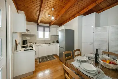 a kitchen and dining room with a table and chairs at Perivolia Panorama - Peaceful Retreat with View in Perivólia