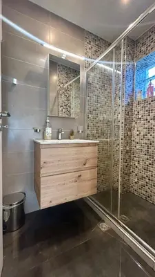 a bathroom with a sink and a shower at Καλαίσθητο Ηλιόλουστο Studio in Chania Town