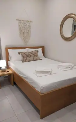 a bedroom with a bed with a mirror on the wall at Roidis Apartments -close to city in Chania Town