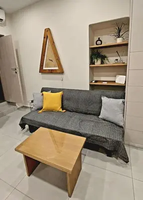 a living room with a couch and a coffee table at Roidis Apartments -close to city in Chania Town