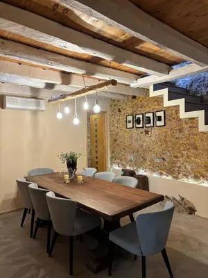 a dining room with a wooden table and chairs at Nature dream 1833 in Dhrakóna