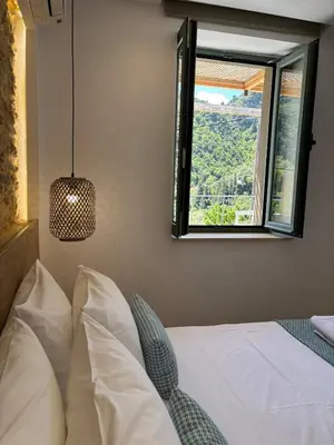 a bedroom with a white bed and a window at Nature dream 1833 in Dhrakóna