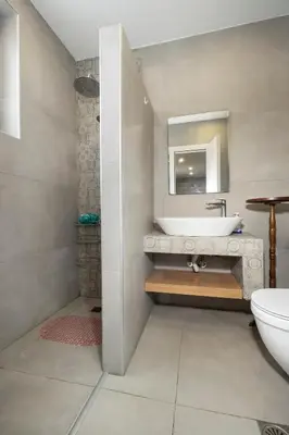a bathroom with a sink and a mirror at Rianou Apartment in Chania Town