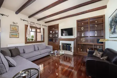 a living room with a couch and a fireplace at Marathi Hilltop Oasis Sea View Villa in Marathi