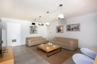 a living room with two couches and a coffee table at Marathi Hilltop Oasis Sea View Villa in Marathi