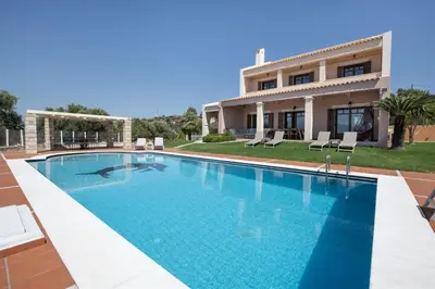a swimming pool in front of a house at Marathi Hilltop Oasis Sea View Villa in Marathi