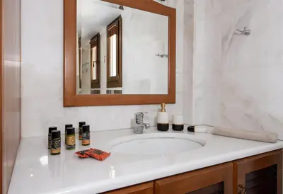 a bathroom with a sink and a mirror at Marathi Hilltop Oasis Sea View Villa in Marathi