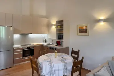 a kitchen with a table with a white table cloth at Lithos Residence in Chania Town
