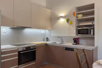 a kitchen with a sink and a microwave at Lithos Residence in Chania Town