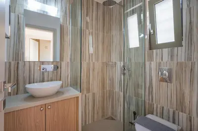 a bathroom with a sink and a mirror at Lithos Residence in Chania Town